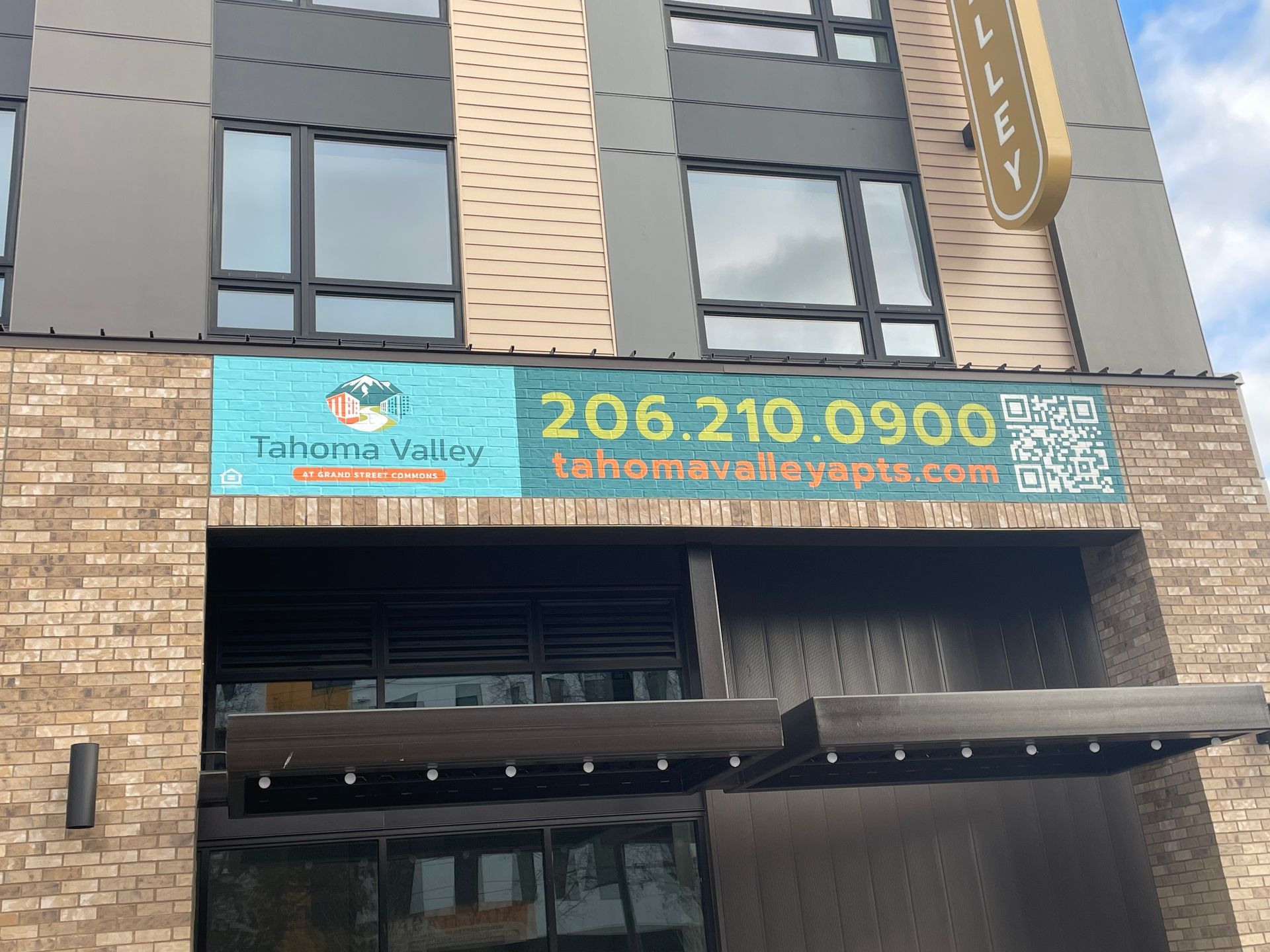 Apartment building entrance with a sign 