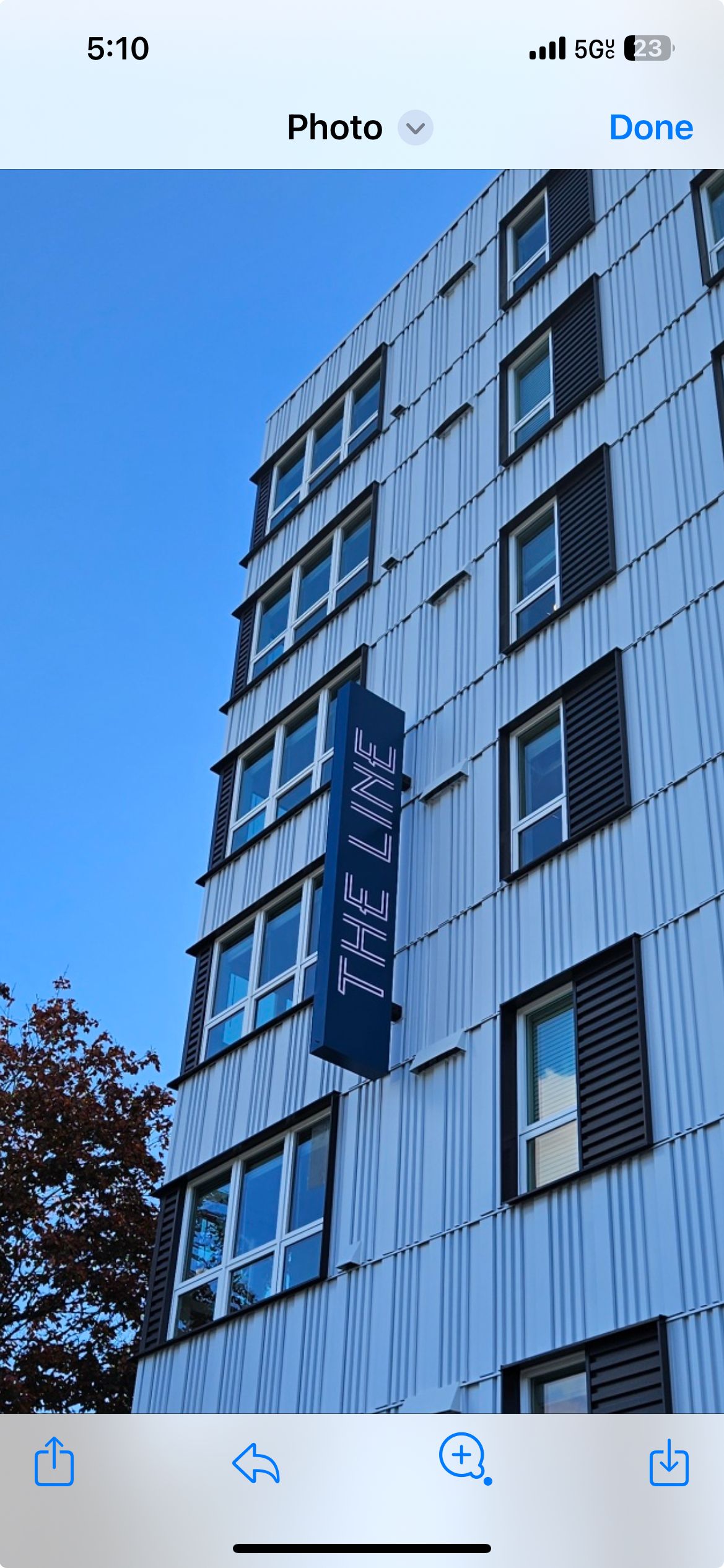 A modern building with vertical blue sign