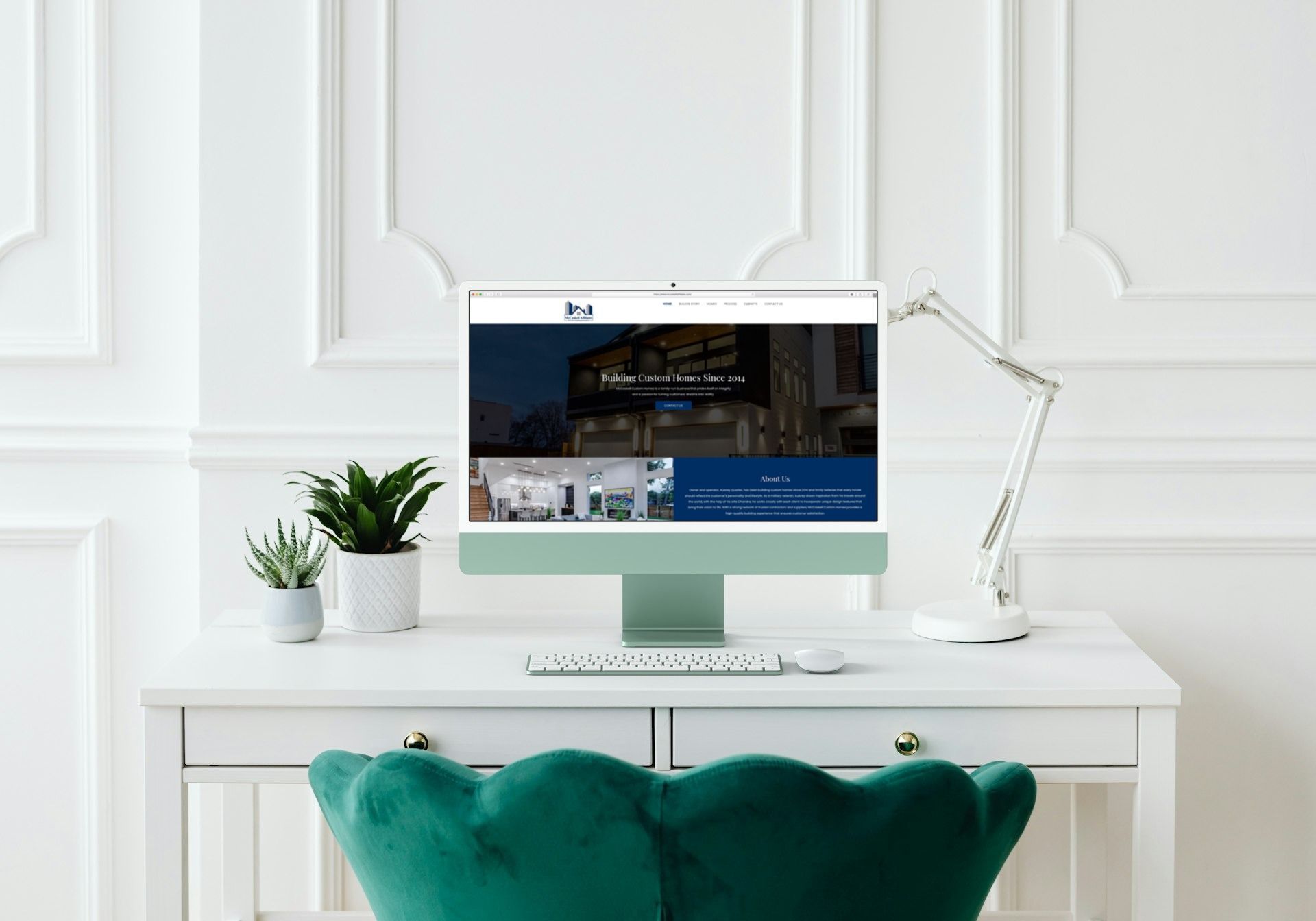 A computer is sitting on a desk next to a green chair.