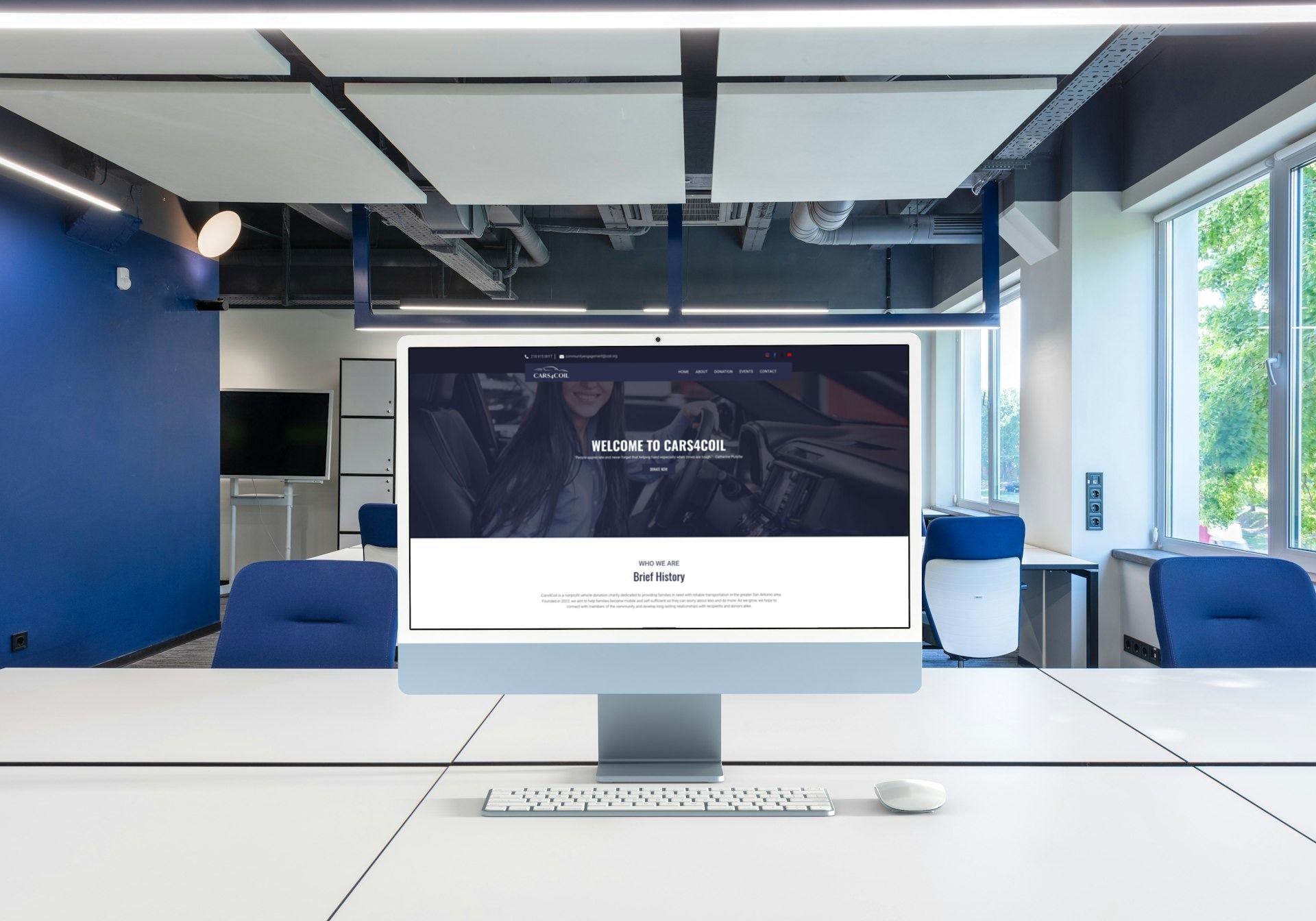A computer monitor is sitting on a desk in an office.