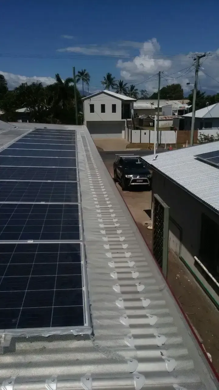 A Row of Solar Panels on the Roof of a Building — All-Clear Gutter Guard NQ in Cairns, QLD