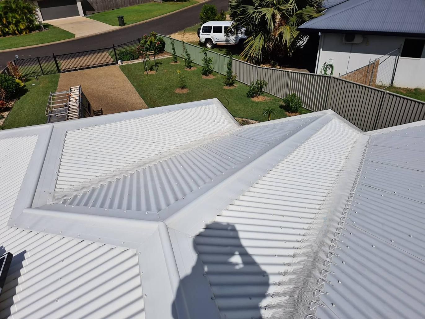 A Shadow of a Person is Cast on the Roof of a House — All-Clear Gutter Guard NQ in Gordonvale, QLD