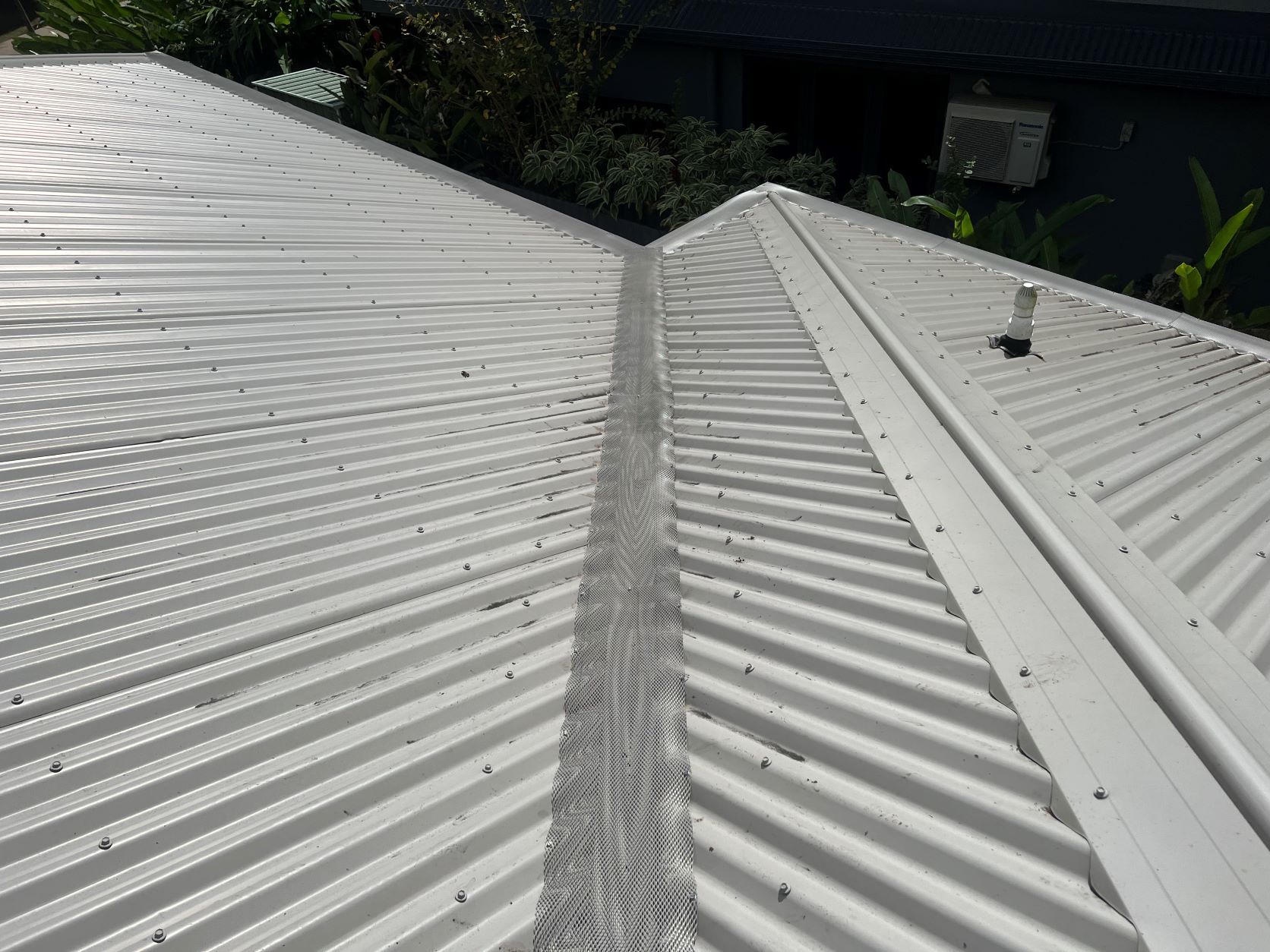 A Close Up of a White Corrugated Metal Roof on a House — All-Clear Gutter Guard NQ in Cairns, QLD