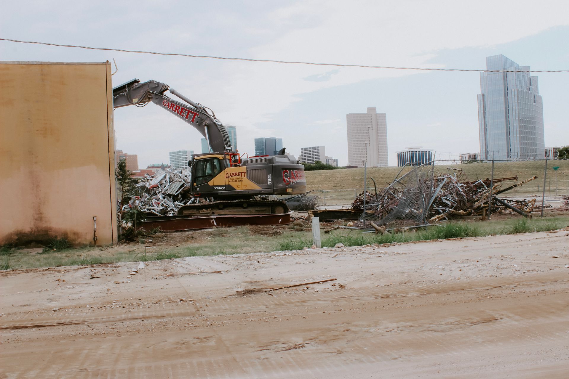 A bulldozer is demolishing a building in a city.