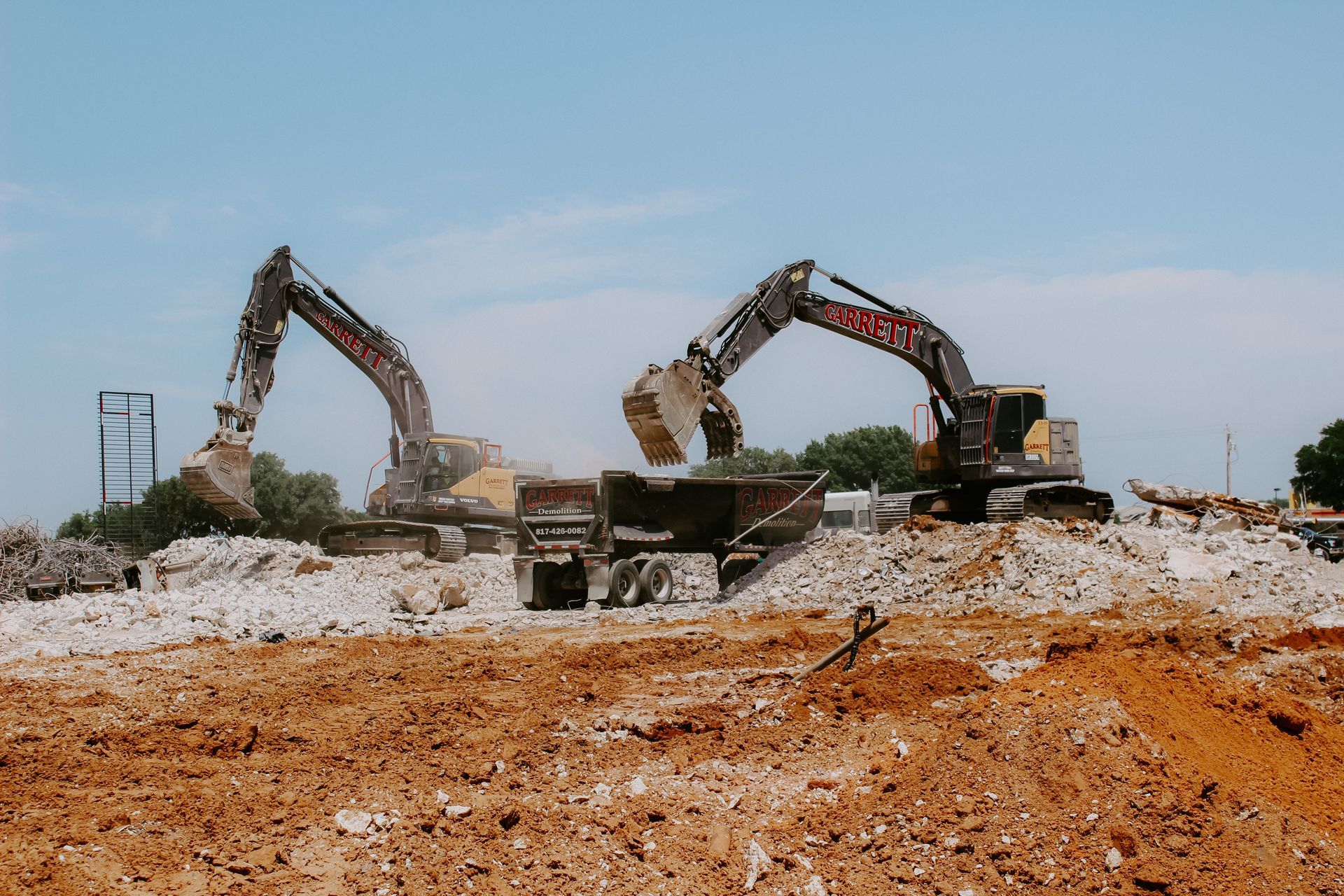 A group of excavators are working on a construction site.