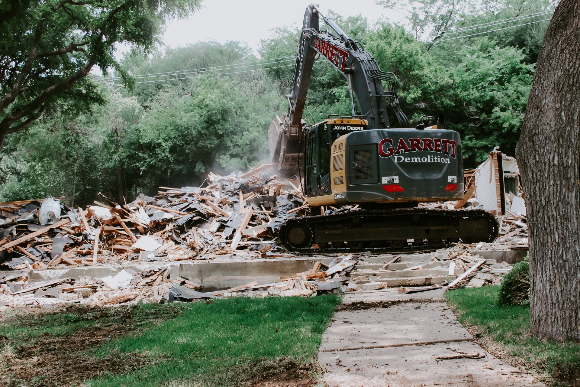 A large excavator is demolishing a house.