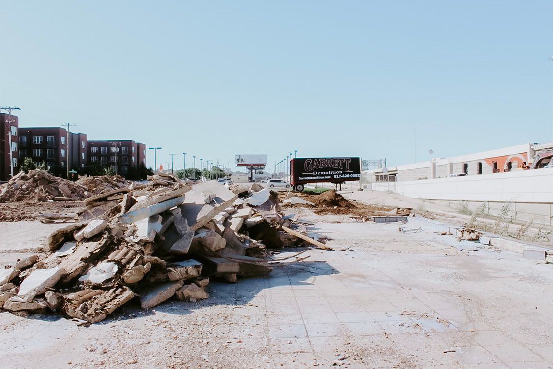 A building is being demolished by a bulldozer.
