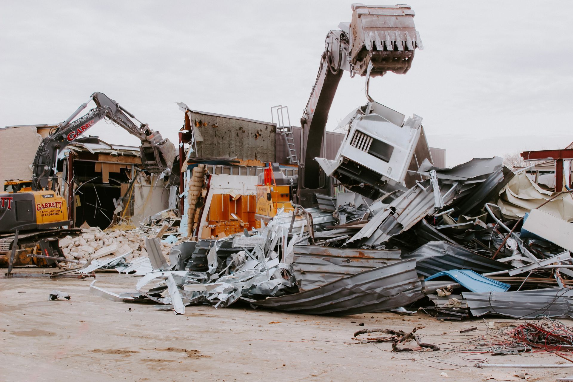 A building is being demolished by a bulldozer.