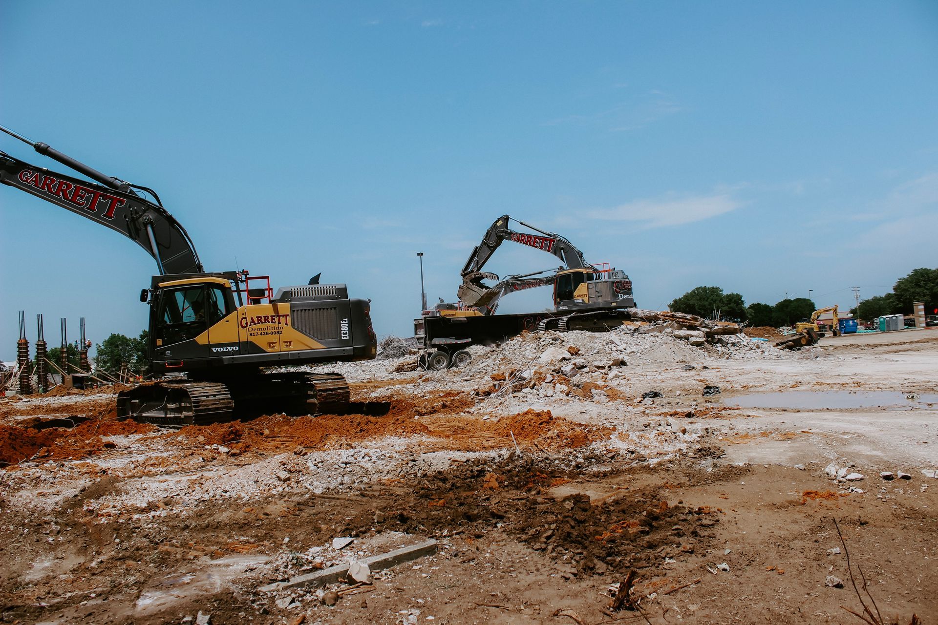 Two excavators are working on a construction site.