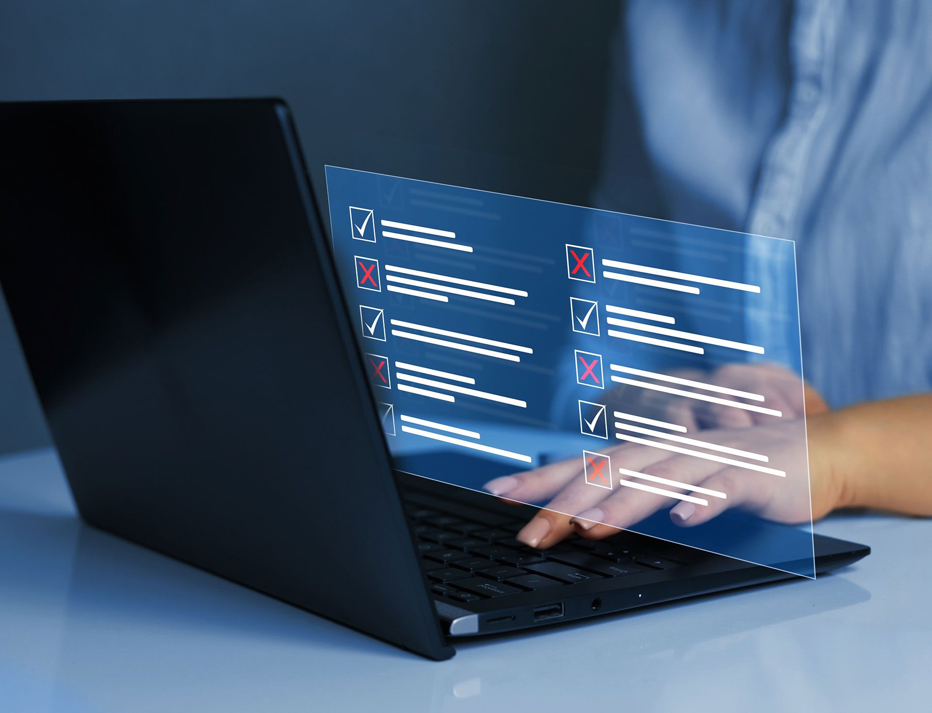 A person is typing on a laptop computer with a checklist on the screen.