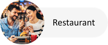 A man and a woman are sitting at a table in a restaurant.