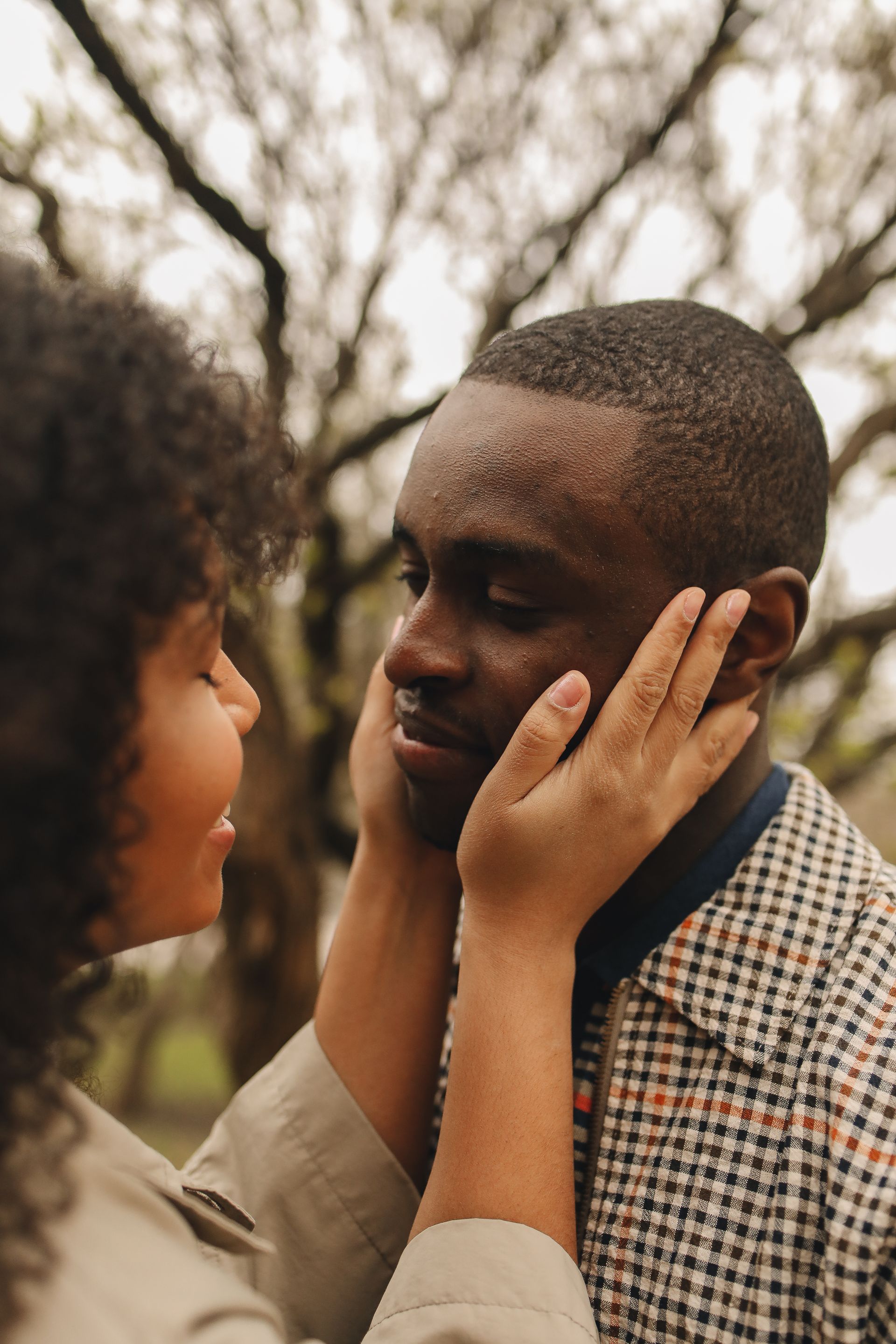 woman holding mans face in her hands looking at him lovingly after a couples therapy session in Grapevine Texas.