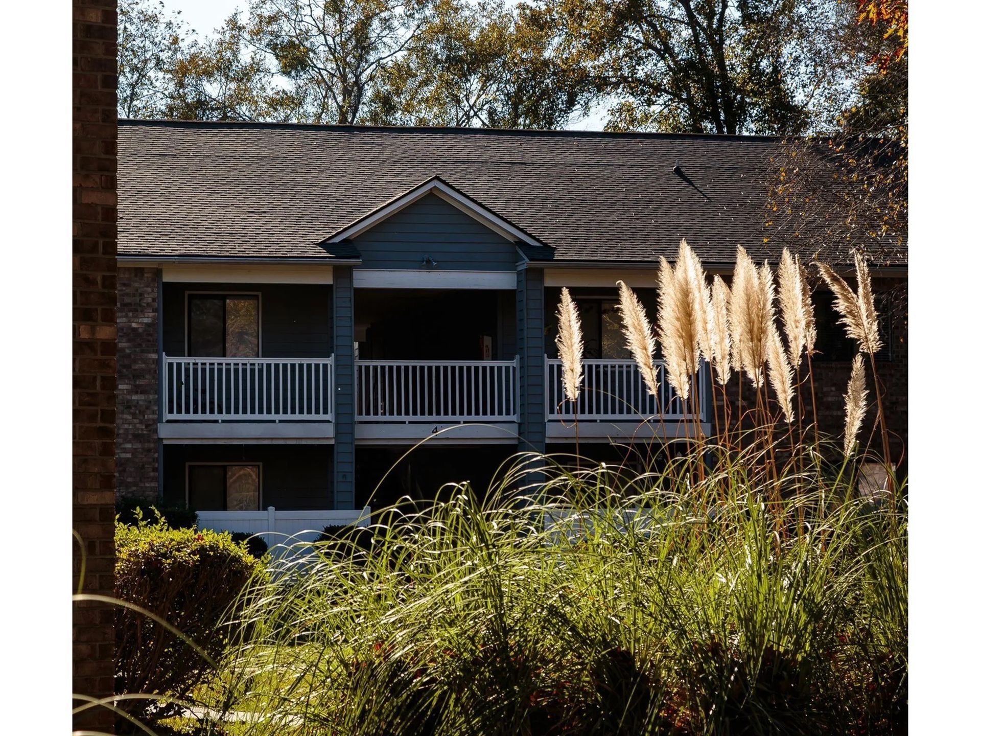 Exterior view of a two-story apartment building with a balcony.