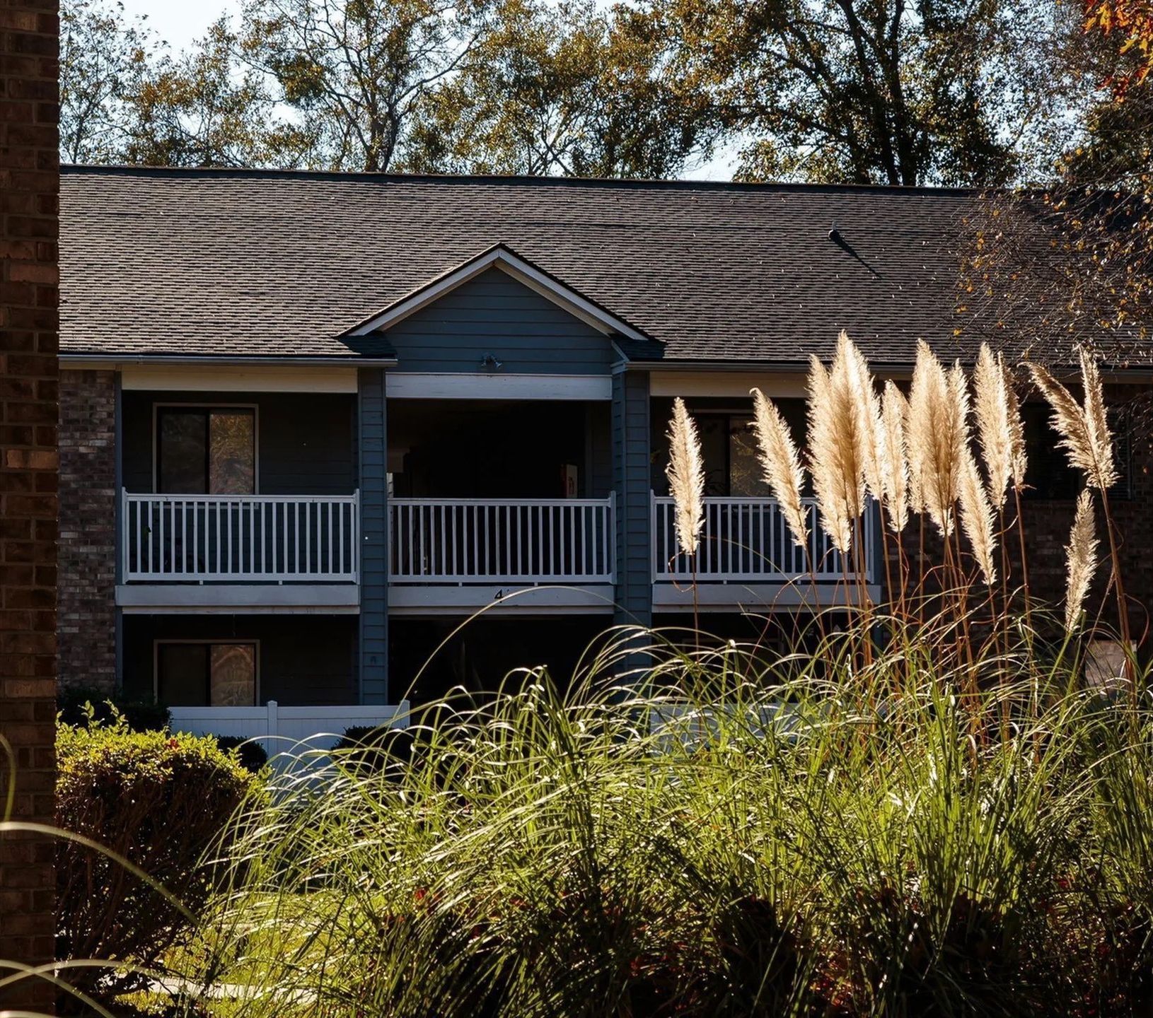 Exterior view of a two-story apartment building with a balcony.