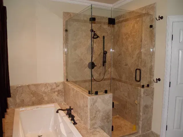 A bathroom with a walk in shower and a bathtub.