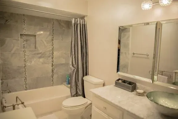 A bathroom with a toilet , sink , tub and shower.