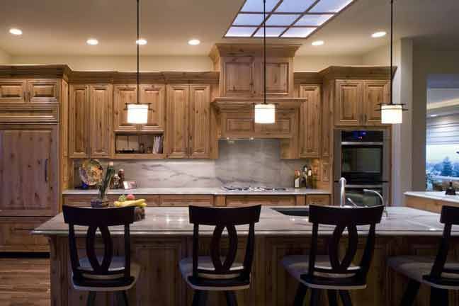 A kitchen with wooden cabinets and a large island.