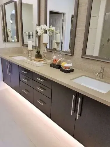 A bathroom with two sinks and two mirrors.