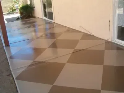 A patio with a checkered floor and a sliding glass door.