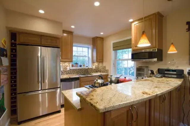A kitchen with stainless steel appliances and granite countertops.