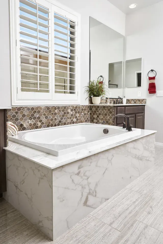 There is a bathtub in the middle of the bathroom.