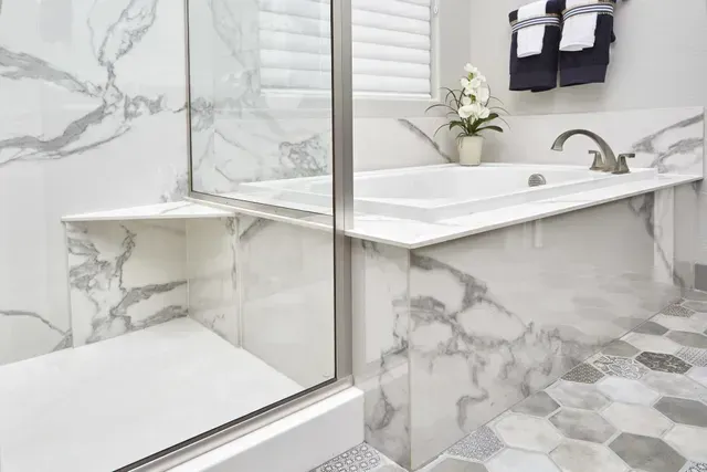 A bathroom with a bathtub and a walk in shower.