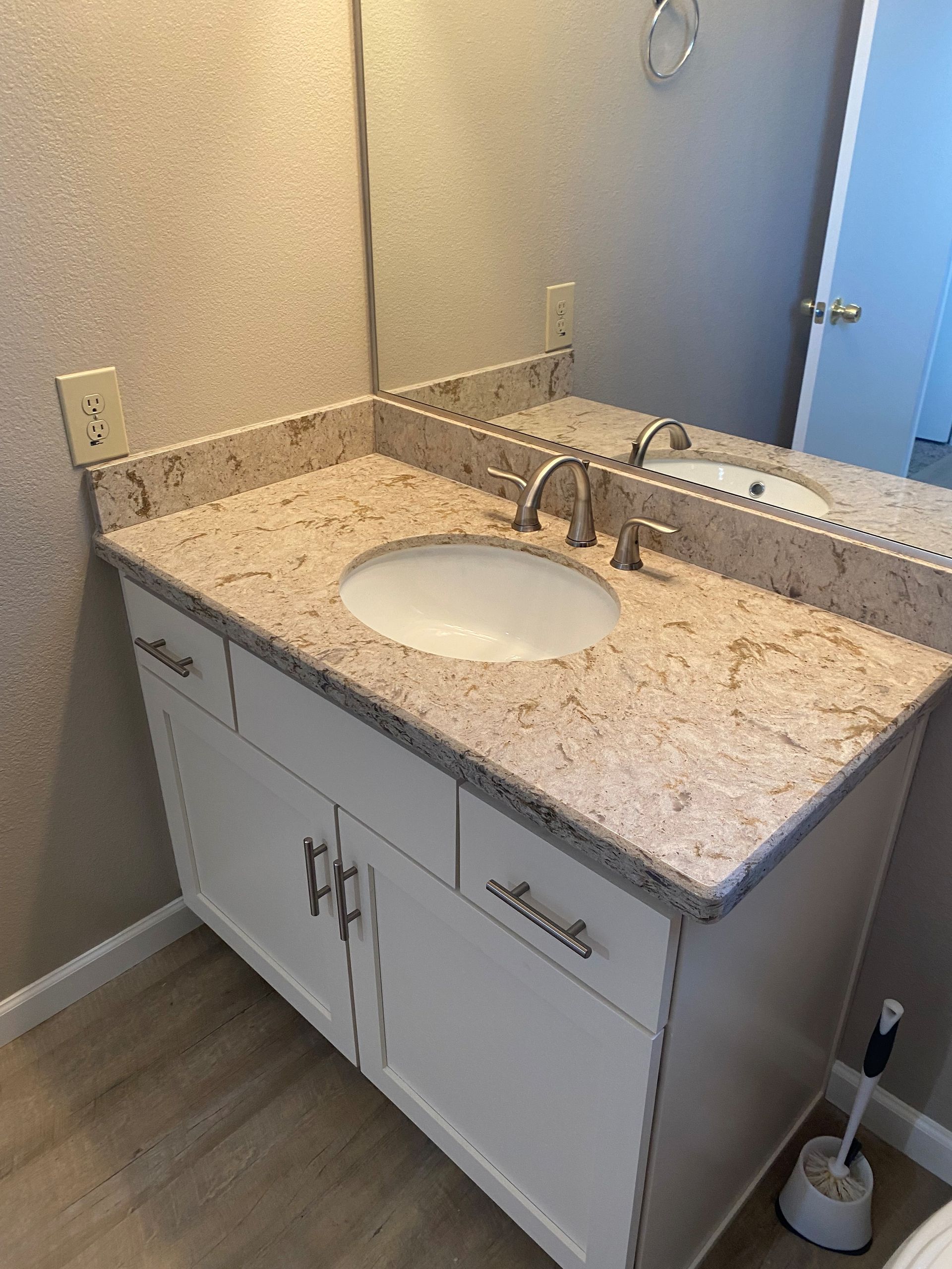 A bathroom with a sink , mirror and toilet.