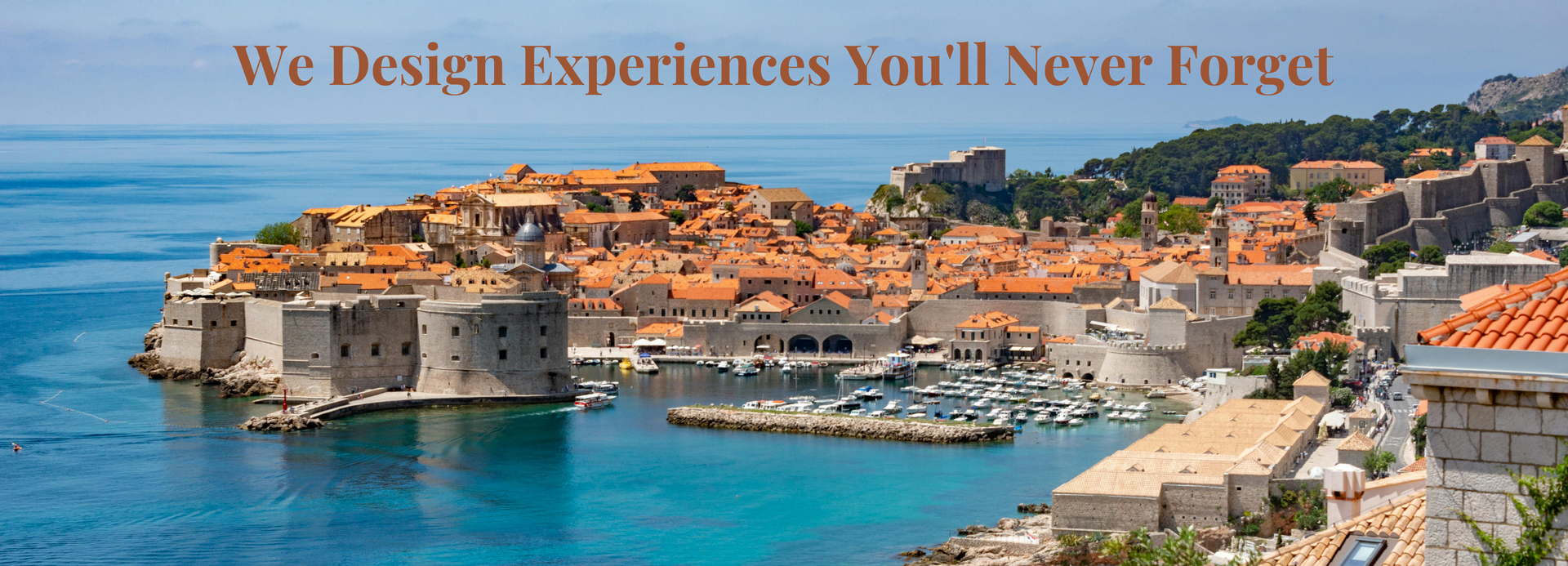 Coastal town of Dubrovnik with stone buildings and blue water, overlaid with “We Design Experiences You’ll Never Forget”