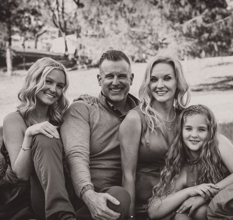 A black and white photo of a family posing for a picture.