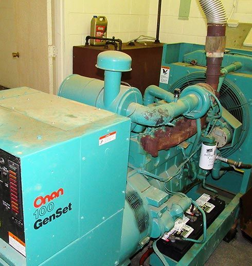 A cyan Orion 100 GenSet generator in an industrial setting with a large fan and exhaust.
