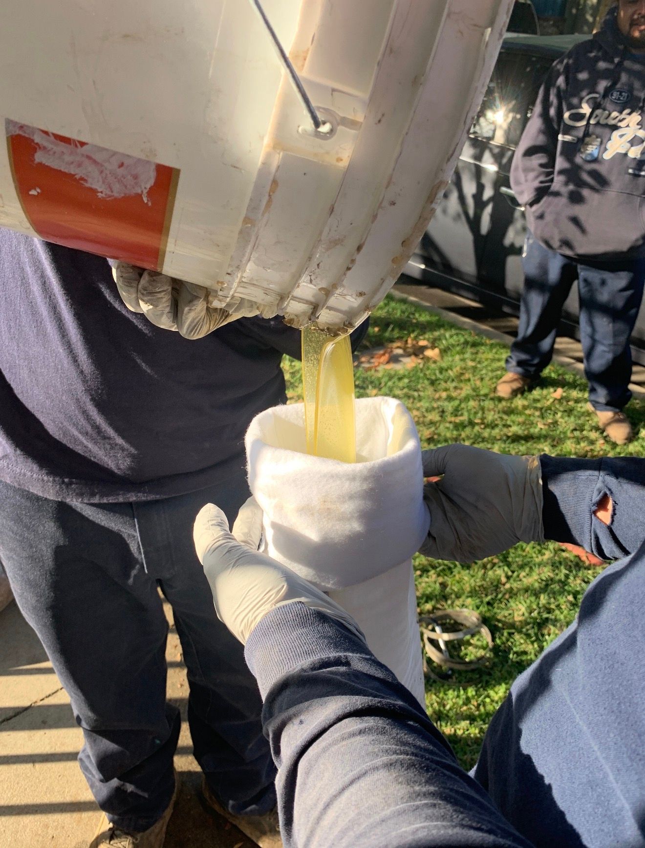 Plumbing technician diagnosing a leak under a sink