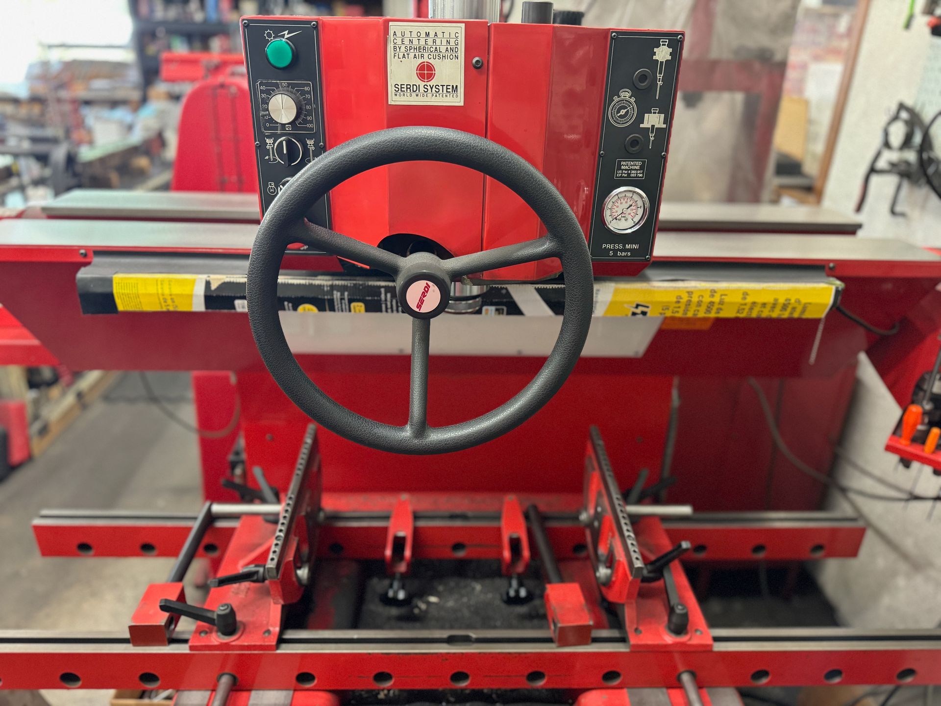 A red machine with a steering wheel on top of it