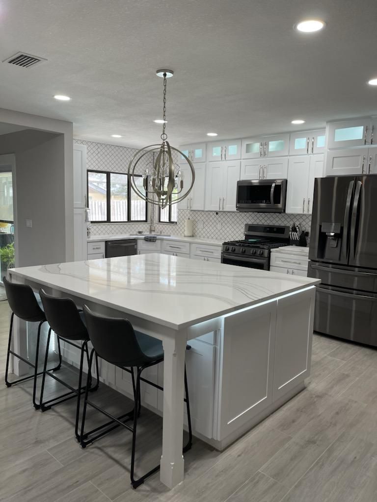There is a large island in the middle of the kitchen.