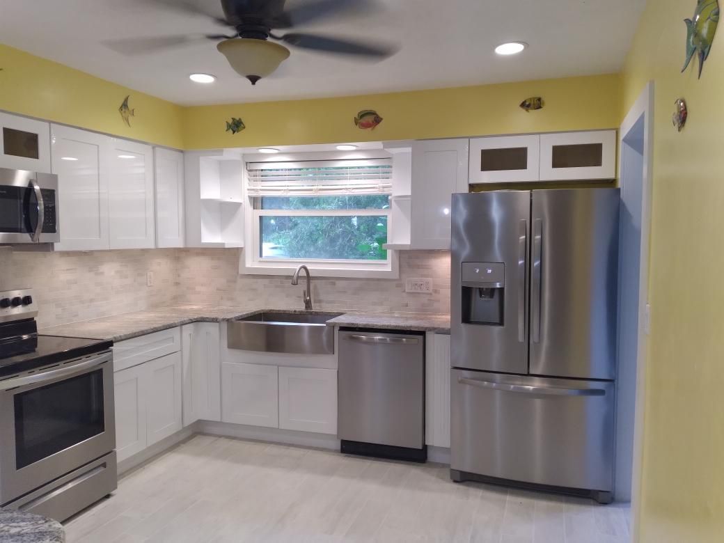 A kitchen with stainless steel appliances and a ceiling fan