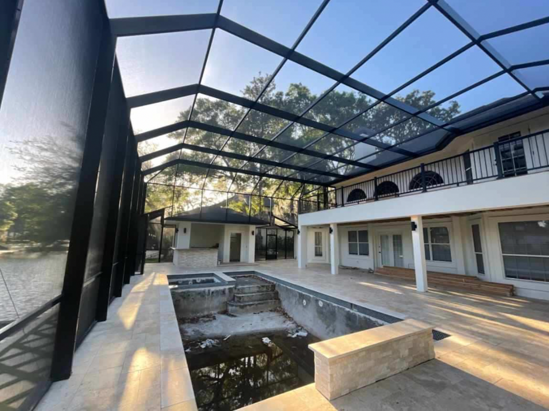 A large house with a swimming pool in the middle of it.