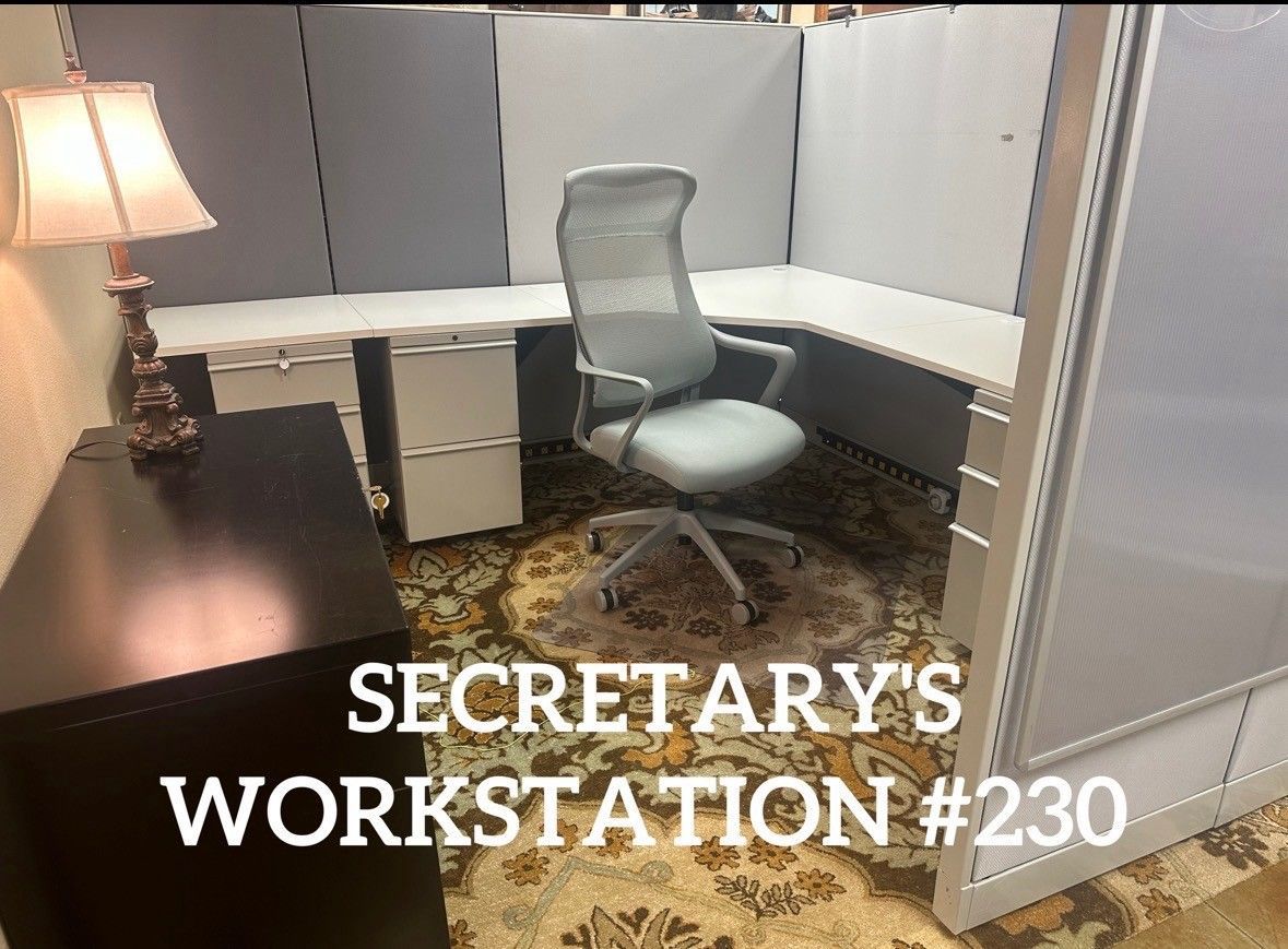 Office interior with a large gray structure, western decor, and a door leading to seating.