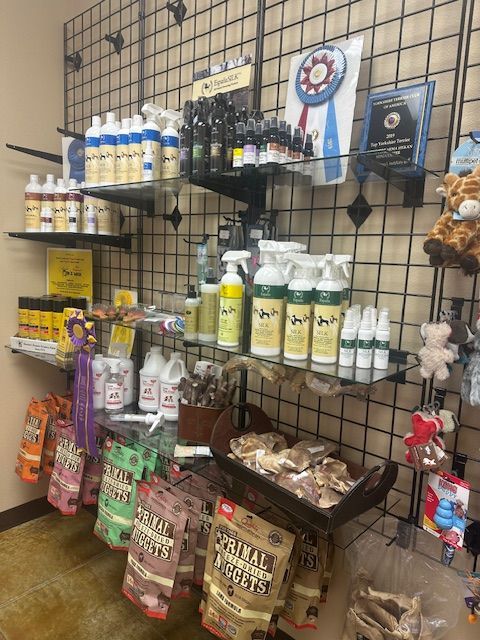 Pet supplies and grooming products displayed on shelves at a store.