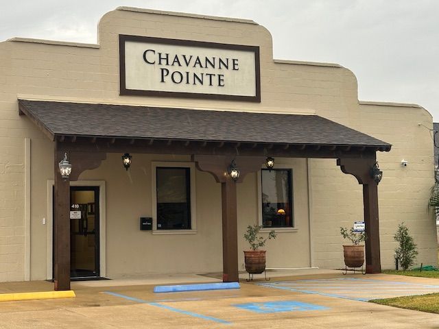 Building facade with a brown awning and the name 