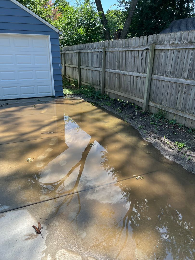 Flooded driveway before new downspout system was installed
