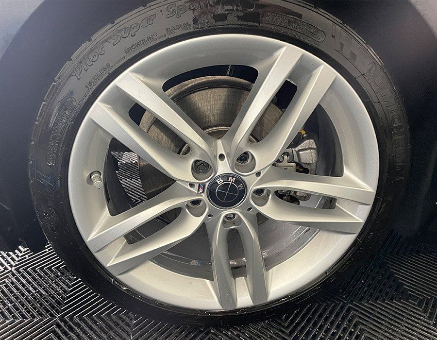 A close up of a car wheel with a tire on it.