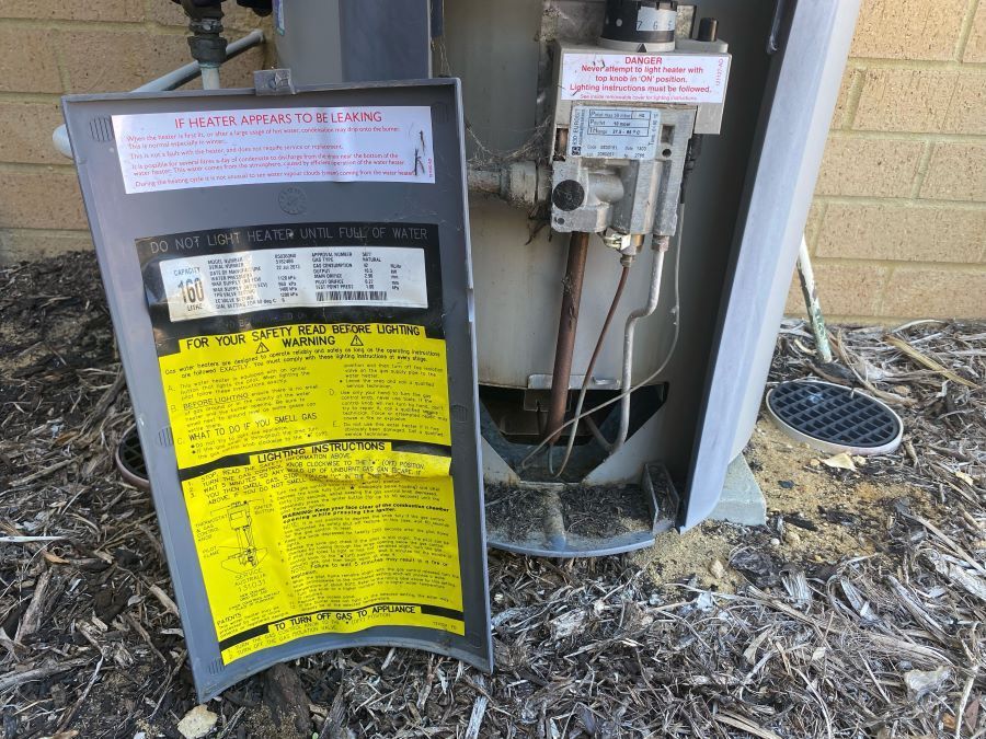 instructions on how to light pilot light located on the back panel of a gas water heater
