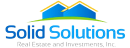 Solid Solutions logo with blue text, yellow rooftops, and gray “Real Estate & Investments” tagline