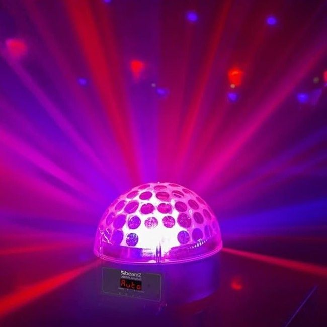 A disco ball light projecting vibrant purple and red beams of light in a dark setting, showing an 'Auto' mode display.