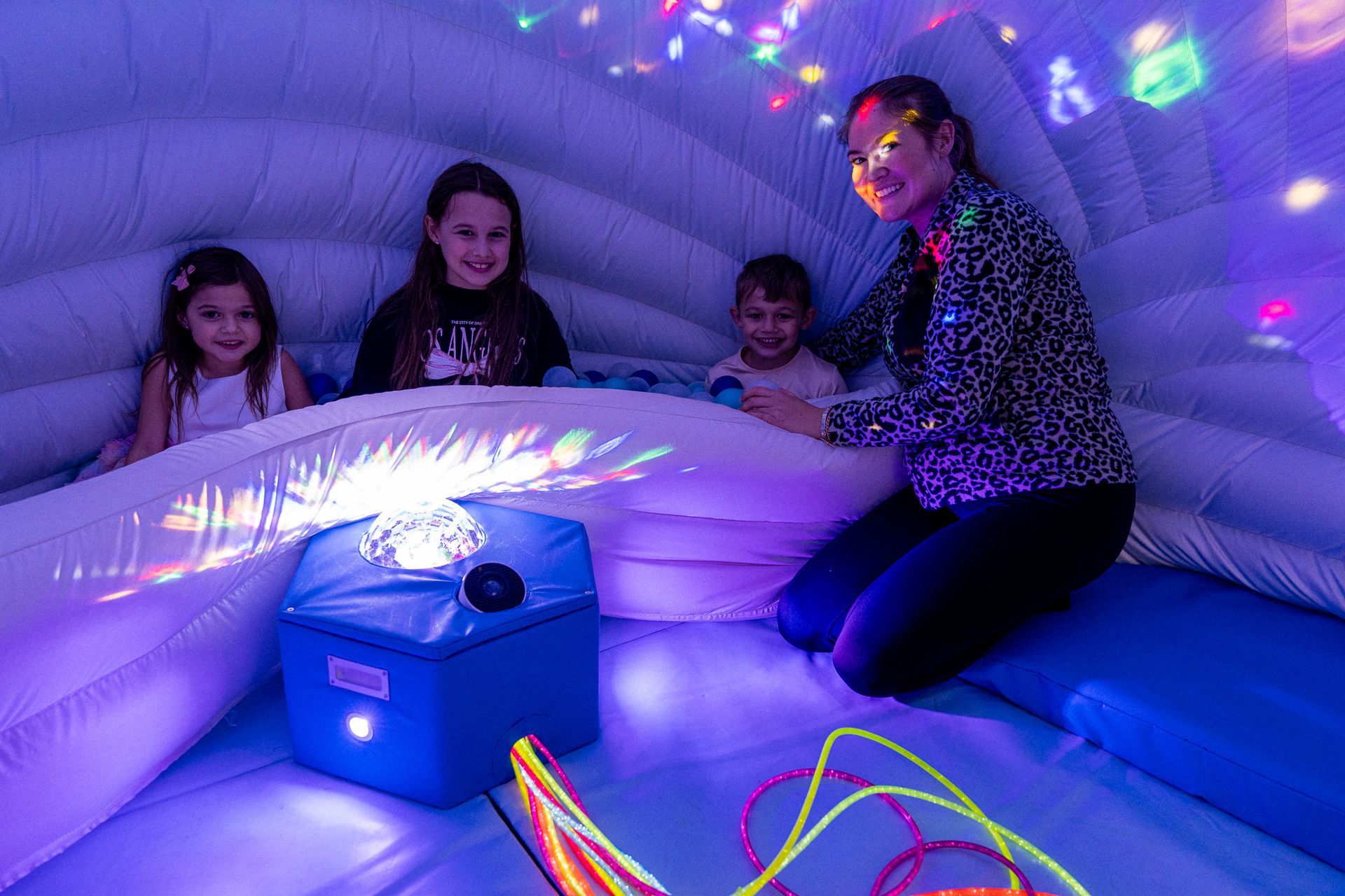 A family enjoy the experience looking at the Ambispace Sensory Igloo