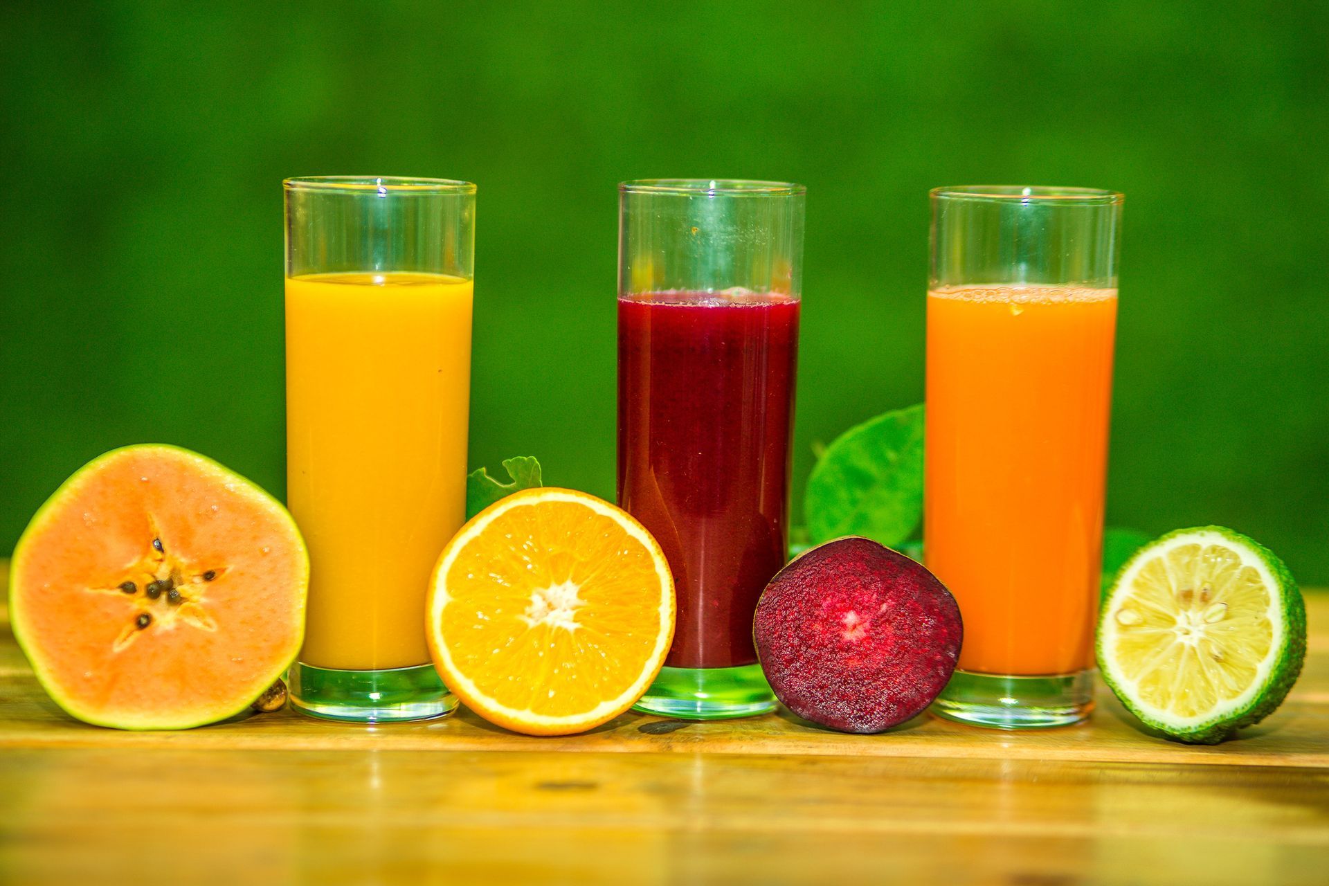 Close-up of fruit juice drink with fruits on table