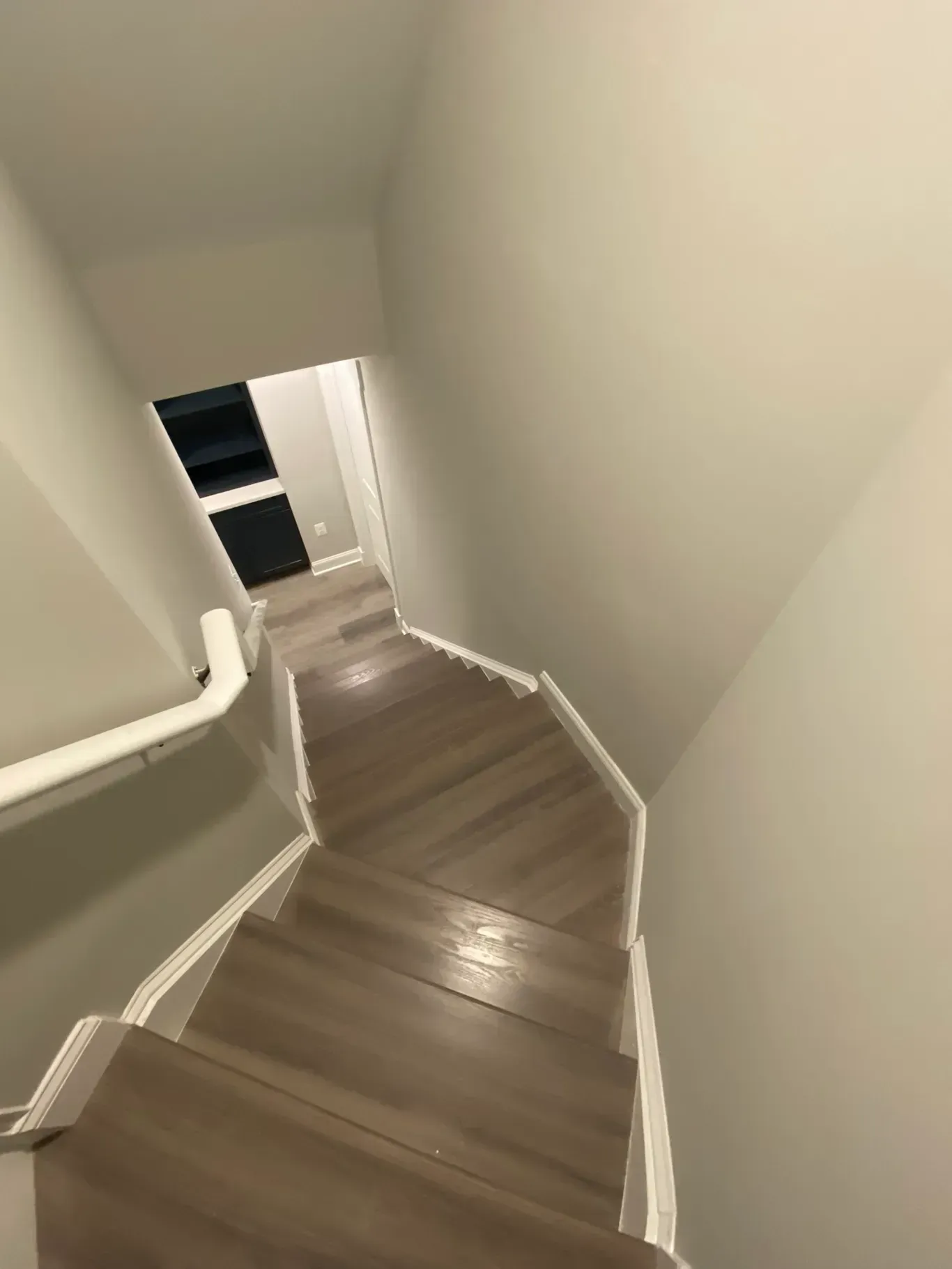 A staircase with wooden steps leading up to a doorway.