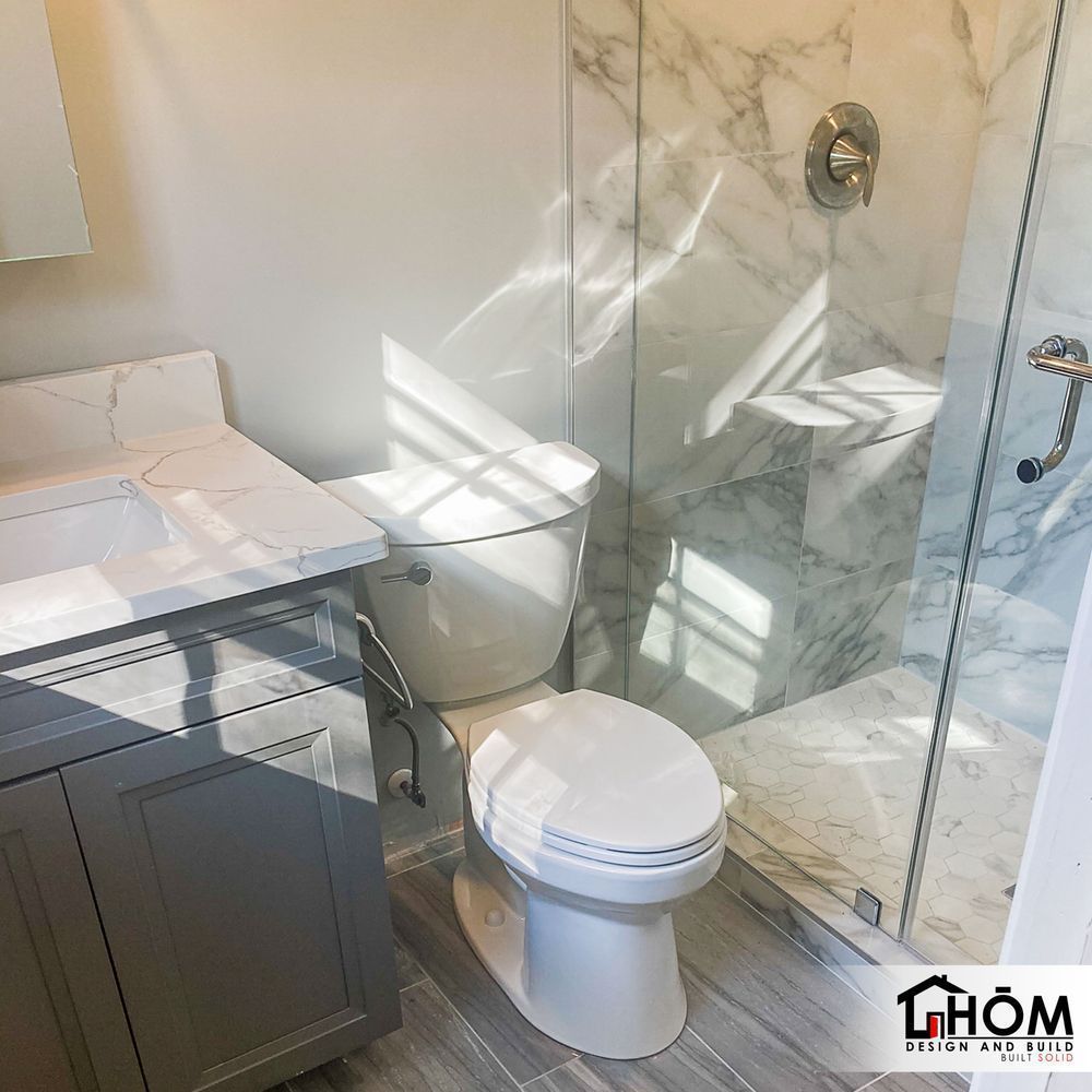 A bathroom with a toilet , sink , and shower.
