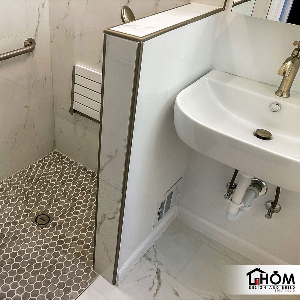 A bathroom with a sink and a walk in shower