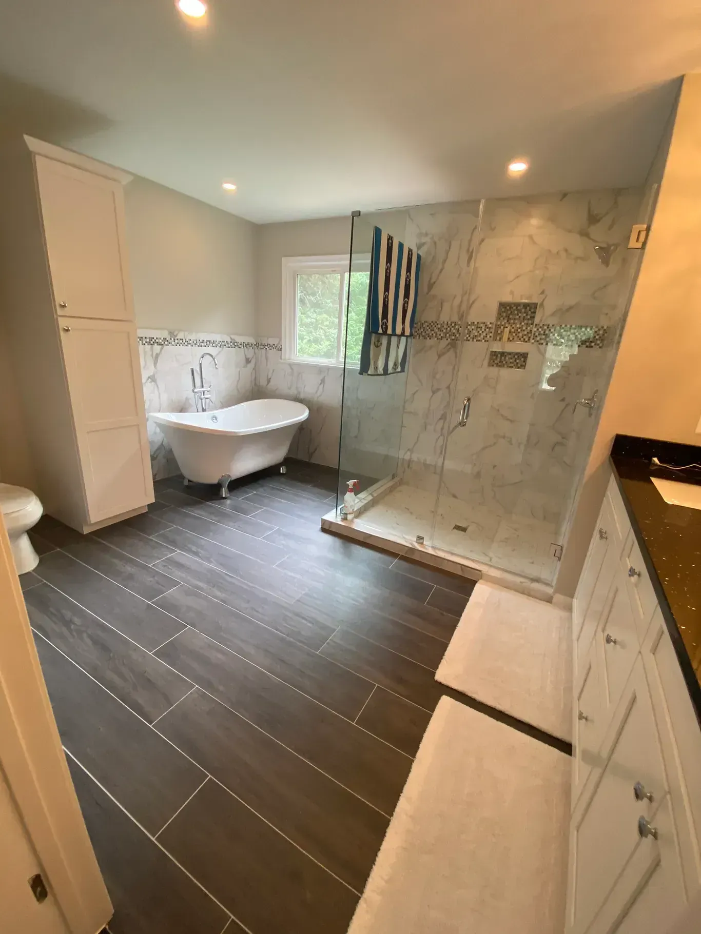 A bathroom with a tub and a walk in shower.