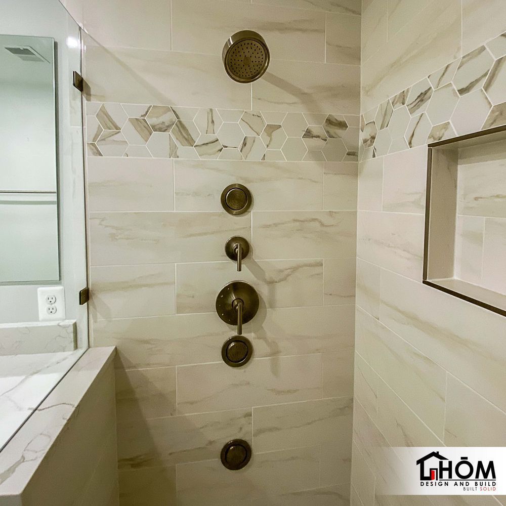 A bathroom with a walk in shower and a sink.